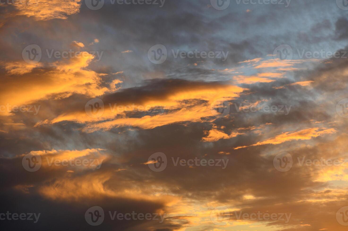 Golden hues dance across the evening sky as darkness begins to fall photo