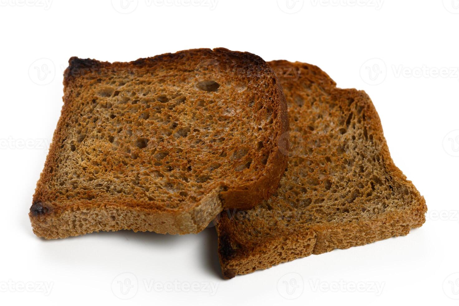 Toasted bread slices sit together on a clean white surface waiting for delicious toppings or spreads photo