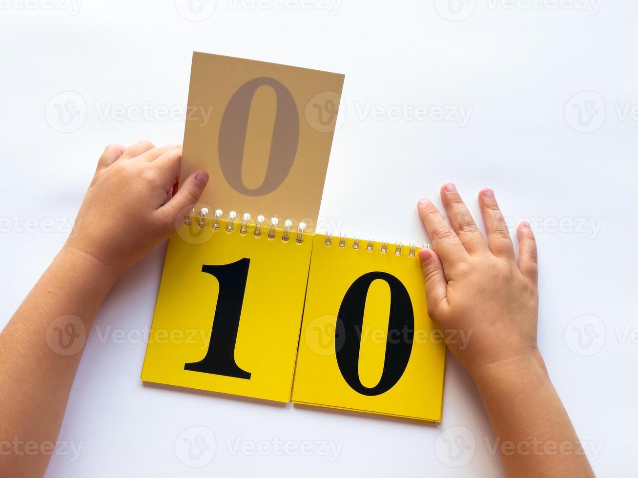 Child learning numbers with educational flashcards on white background photo