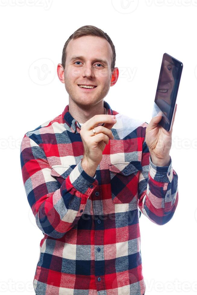 white-skinned male freelancer, repairman, scratches the protective film on the tablet screen and removes it. wearing a shirt. Emotional portrait. Isolated on white background photo