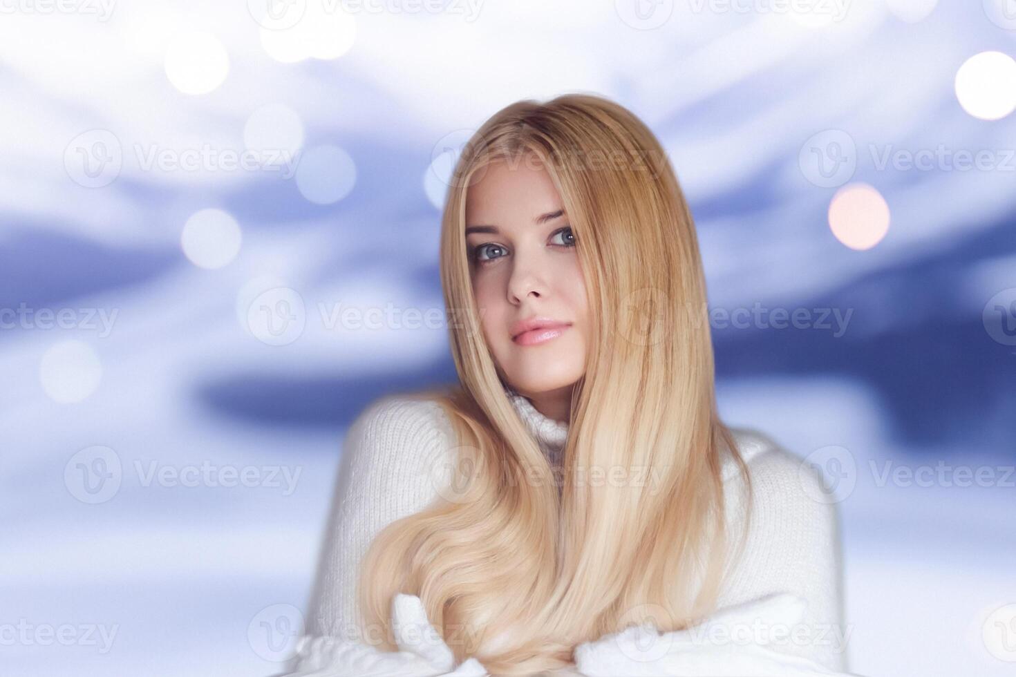 Blonde woman wearing warm mittens, knitted jumper, winter snow nature background with copyspace fashion and lifestyle photo
