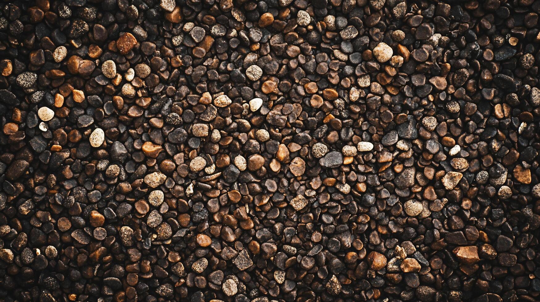 Close up of a pile of rocks with a brownish color. The rocks are scattered all over the ground and some of them are larger than others. The image has a natural and earthy feel to it photo