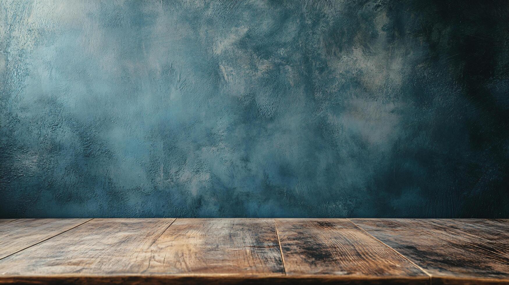 Wooden table with a blue wall behind it. The table is empty and the wall is painted blue photo