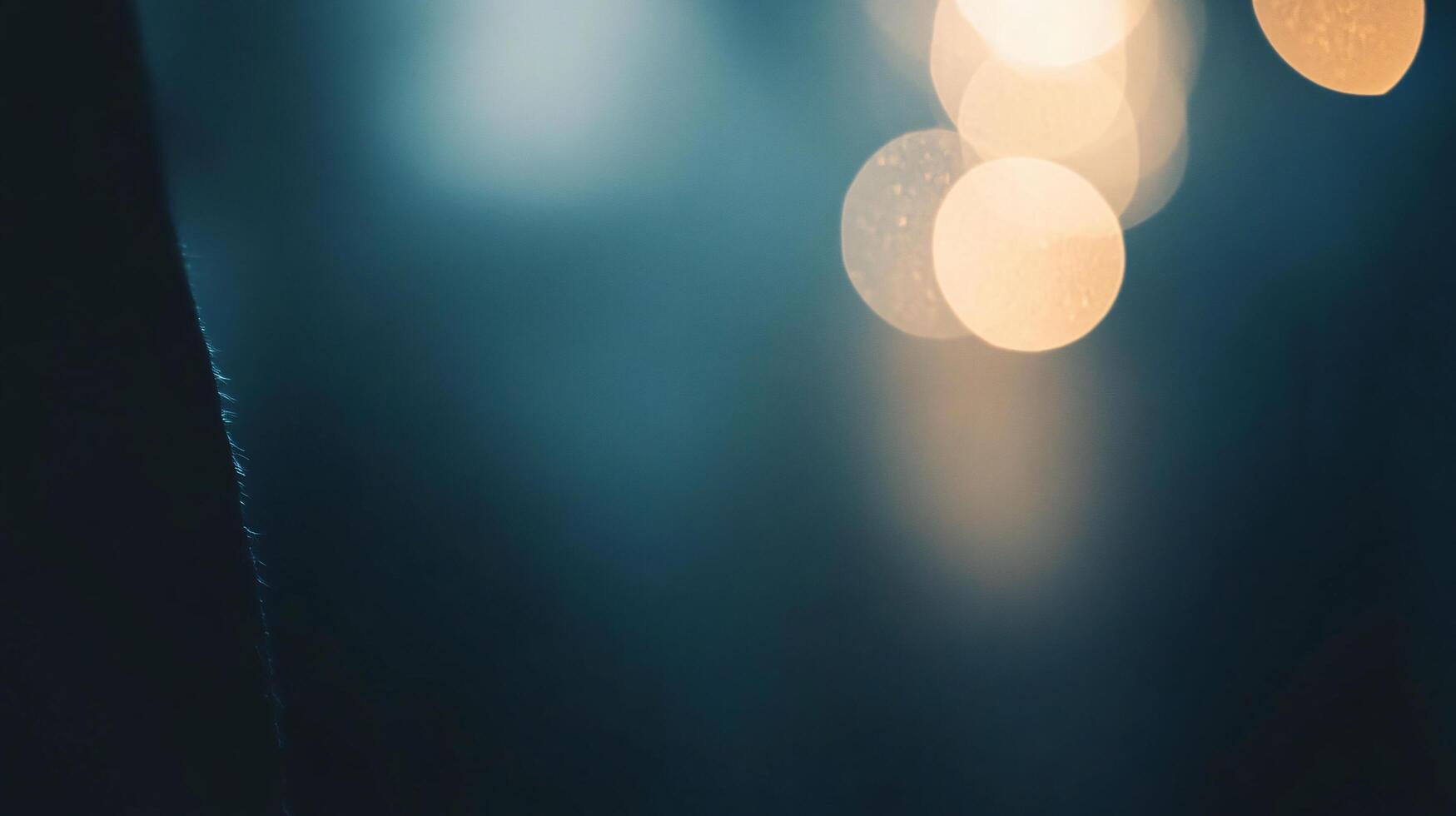 Blurry image of a city street with a dark blue background and yellow lights. The image has a moody and mysterious feel to it photo