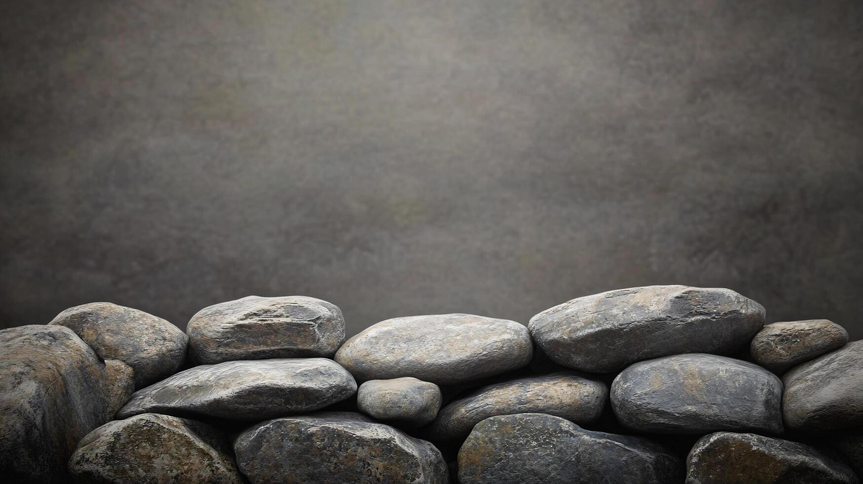 Wall of rocks with a gray background. The rocks are of various sizes and are piled up in a way that creates a sense of depth and texture photo