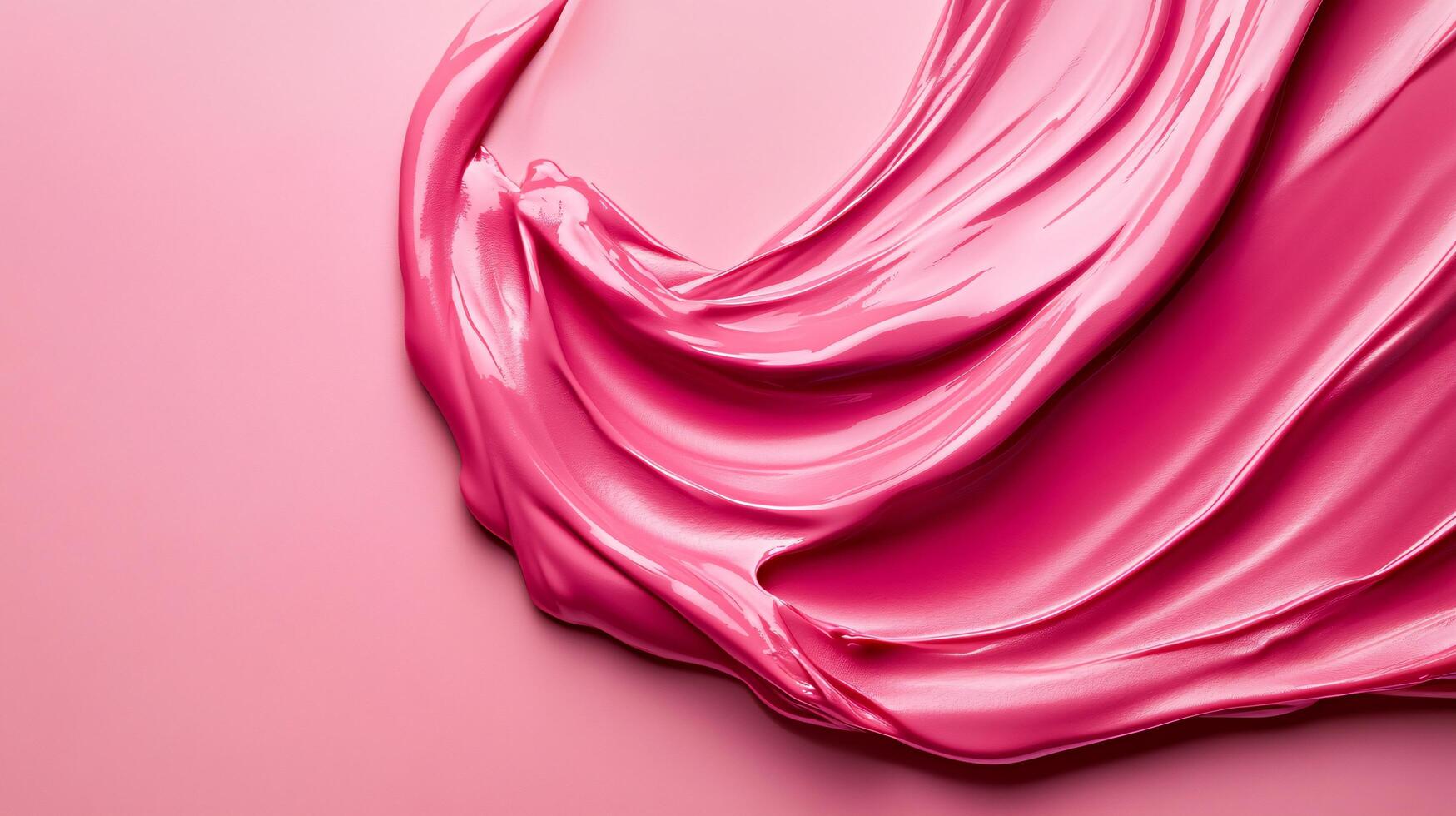 Pink liquid is flowing down a surface. The liquid is thick and has a shiny appearance photo