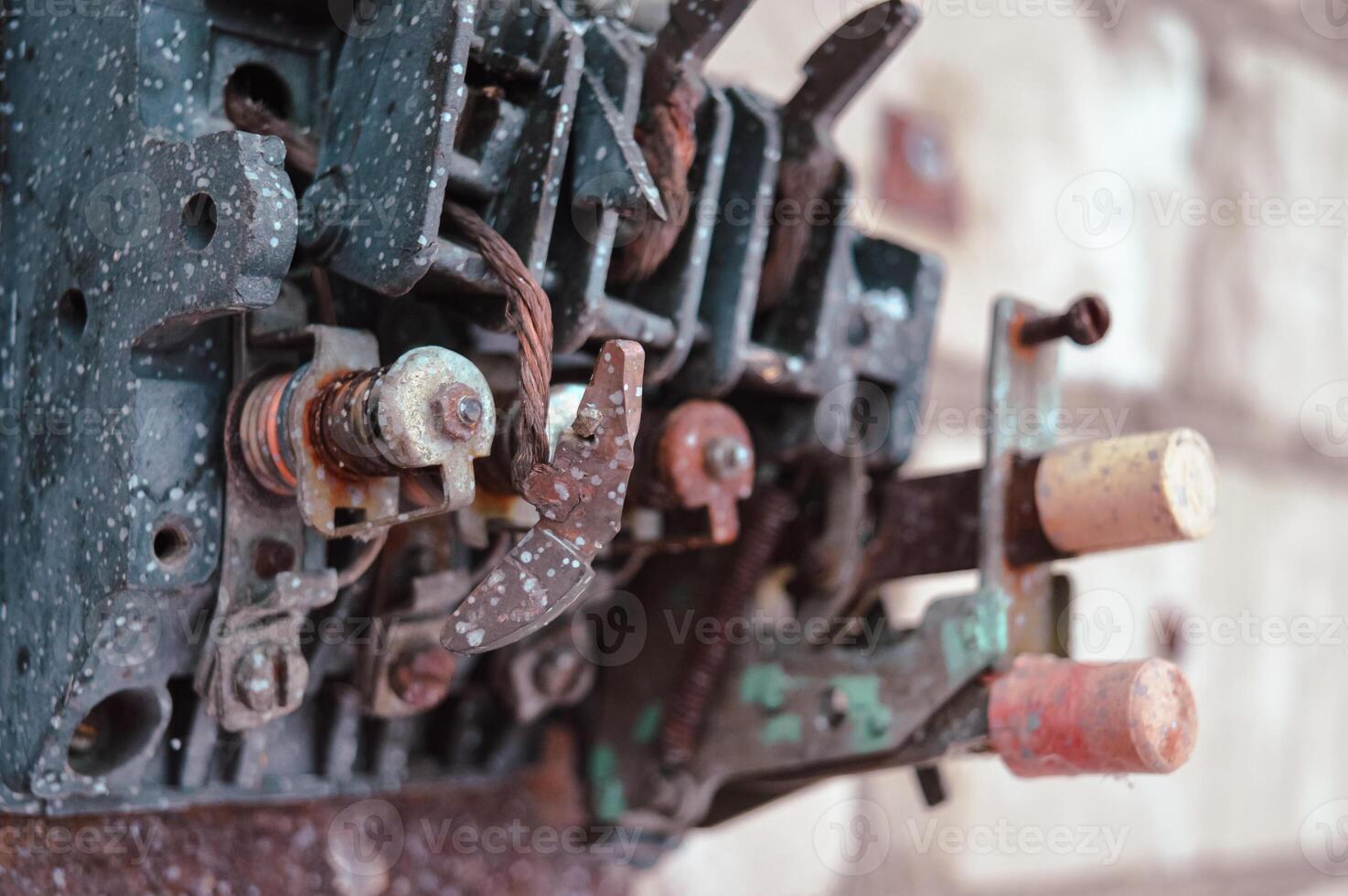 an old broken switch mechanism in which the insides with small wires, bolts and other electrically conductive filling. Old plastic copper and silver contacts. depressing post-apocalyptic View of a photo