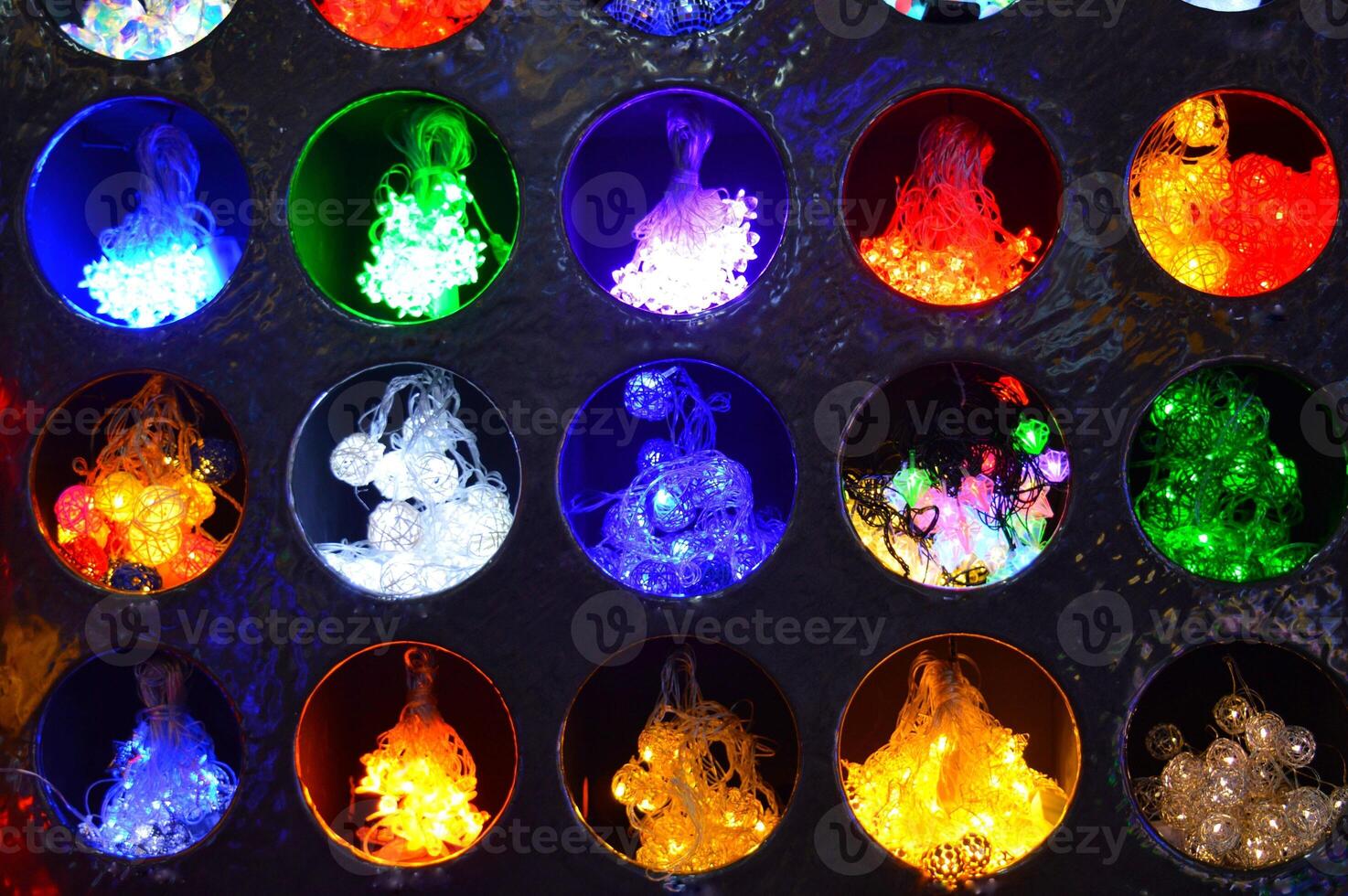 abstract background of multicolored lights burning in recesses each in its own circle. High quality photo