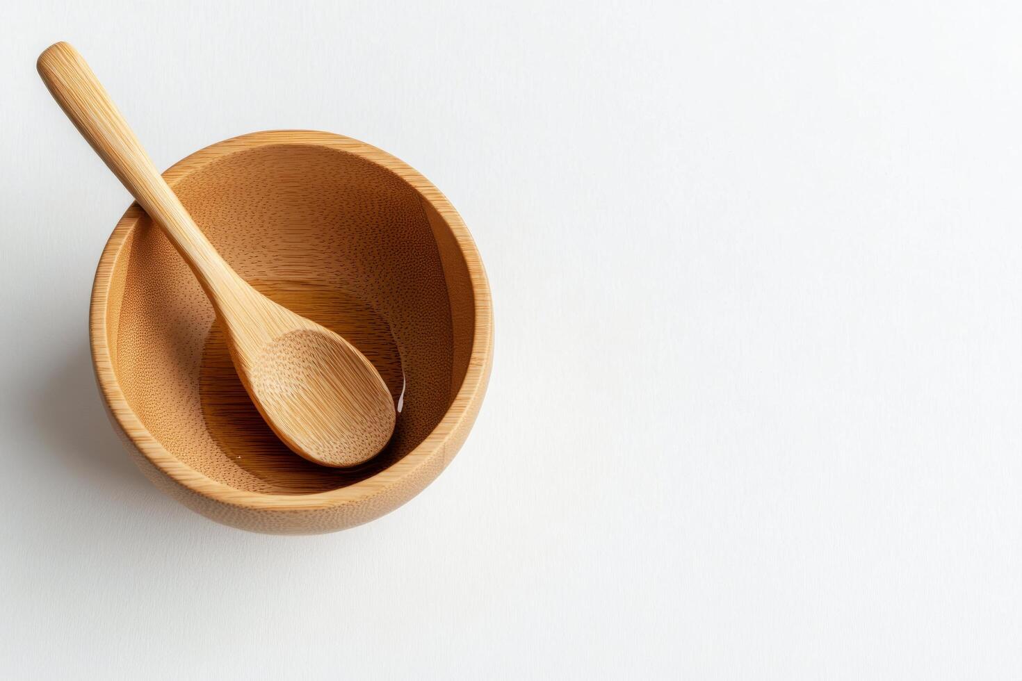 Wooden bowl with spoon on a plain background for culinary presentation photo