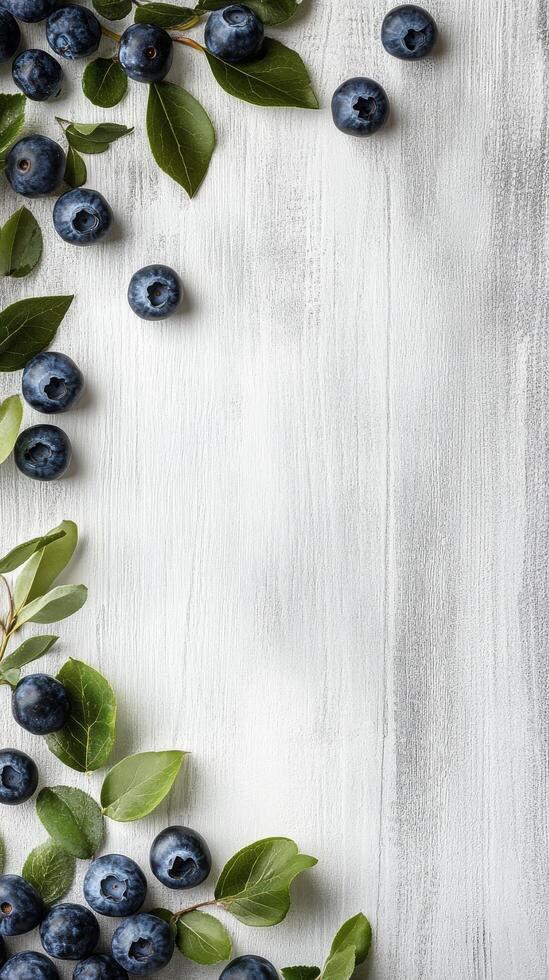 Blueberries on a rustic wooden surface with a light blue background photo
