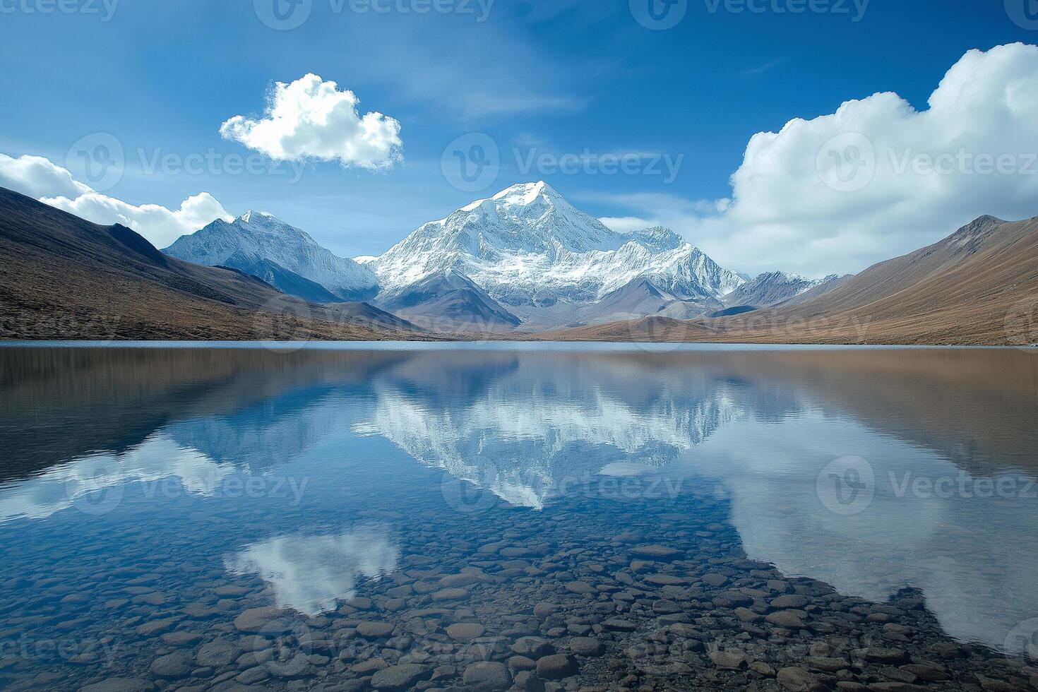 Reflections of majestic mountains and clouds in crystal-clear lake under a vibrant sky. photo