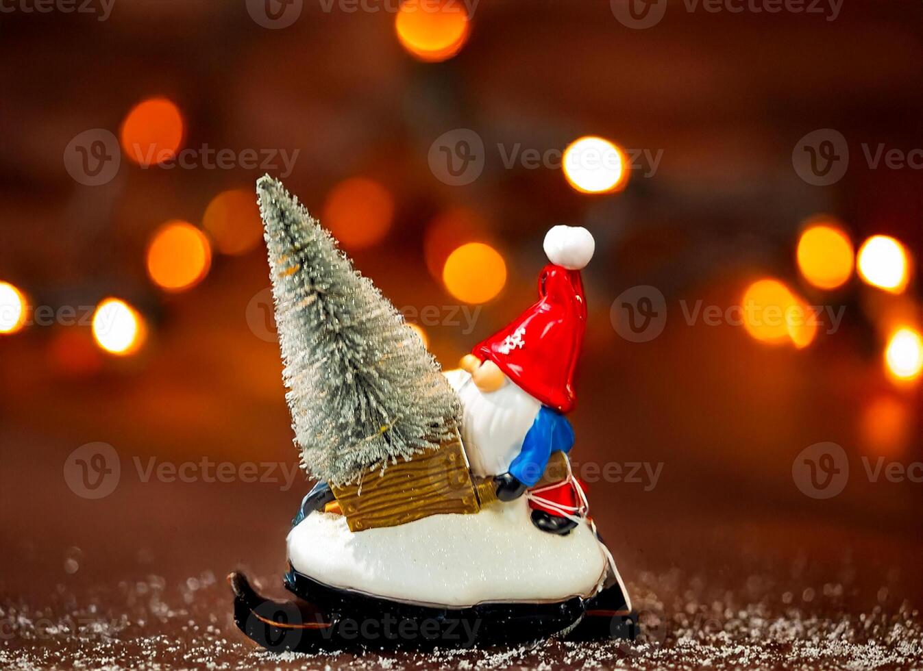 Christmas gnome sitting by decorated Christmas tree, holiday lights background photo