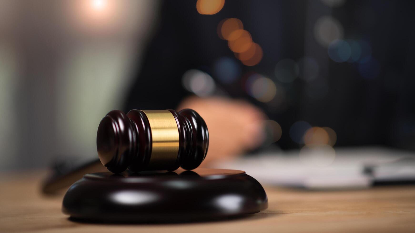 Wooden judge gavel on table ,justice in punishment of offenses and criminal verdicts ,concept of law and justice ,legal contract consulting ,court proceedings ,planning for court proceedings photo