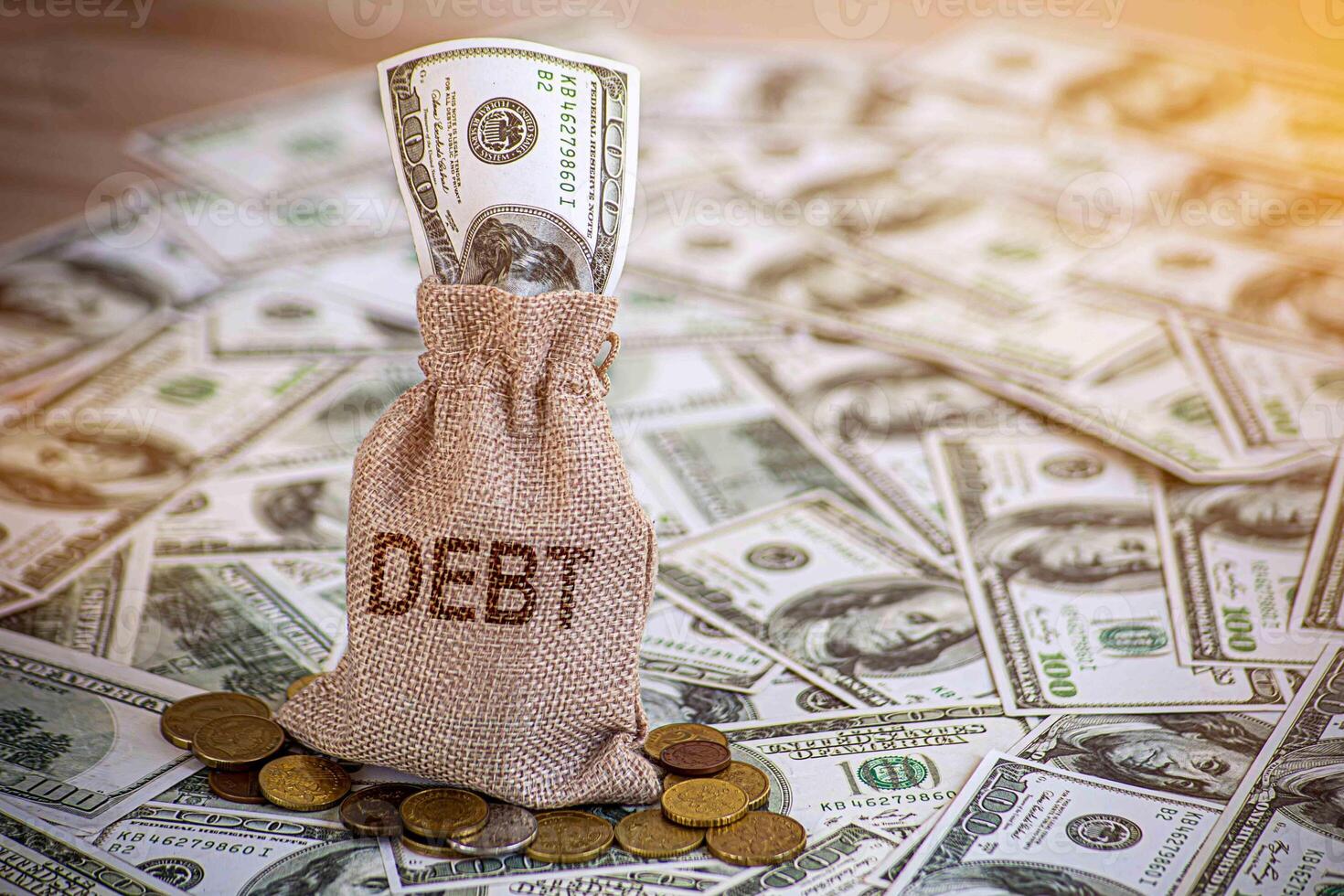Financial debt concept. A man hand on stack of coins and money bag showing about debt. photo