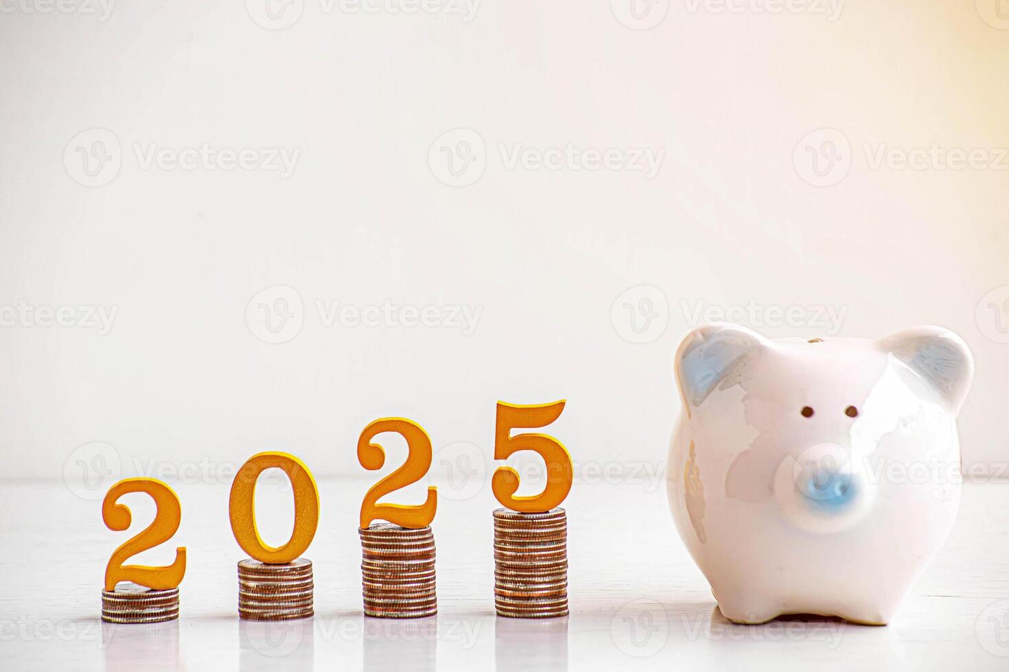 2025 New year saving money pig piggy bank with Wooden number 2025 Gold color on coins stack. Money-saving concept photo