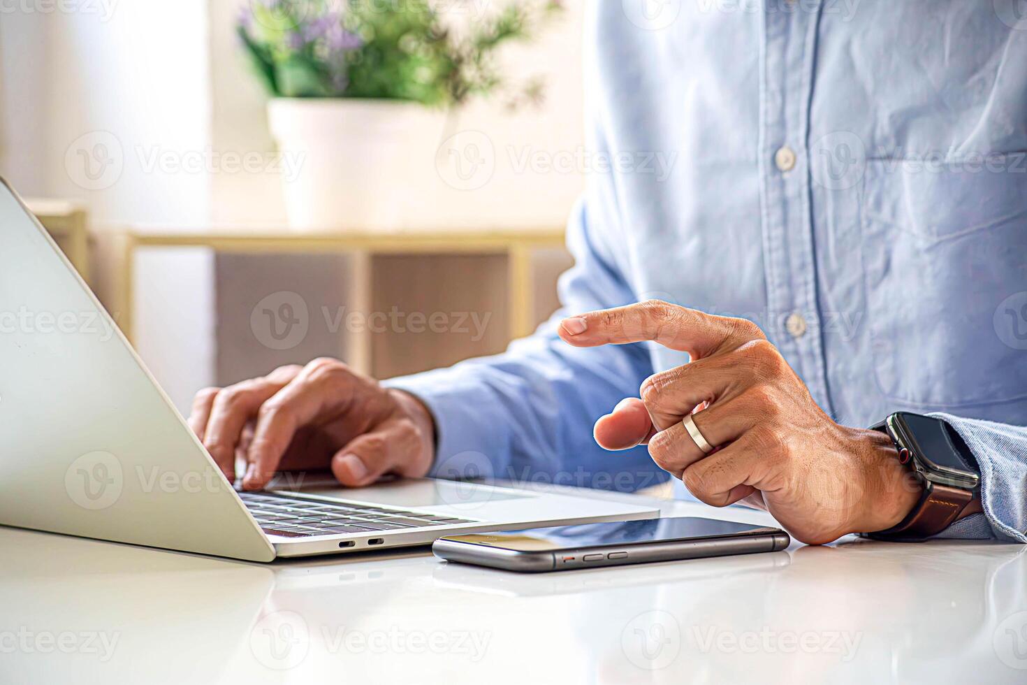Close-up A businessman use laptop computers to working in a private room, He is typing on a laptop keyboard, Concept of using technology in communication. photo