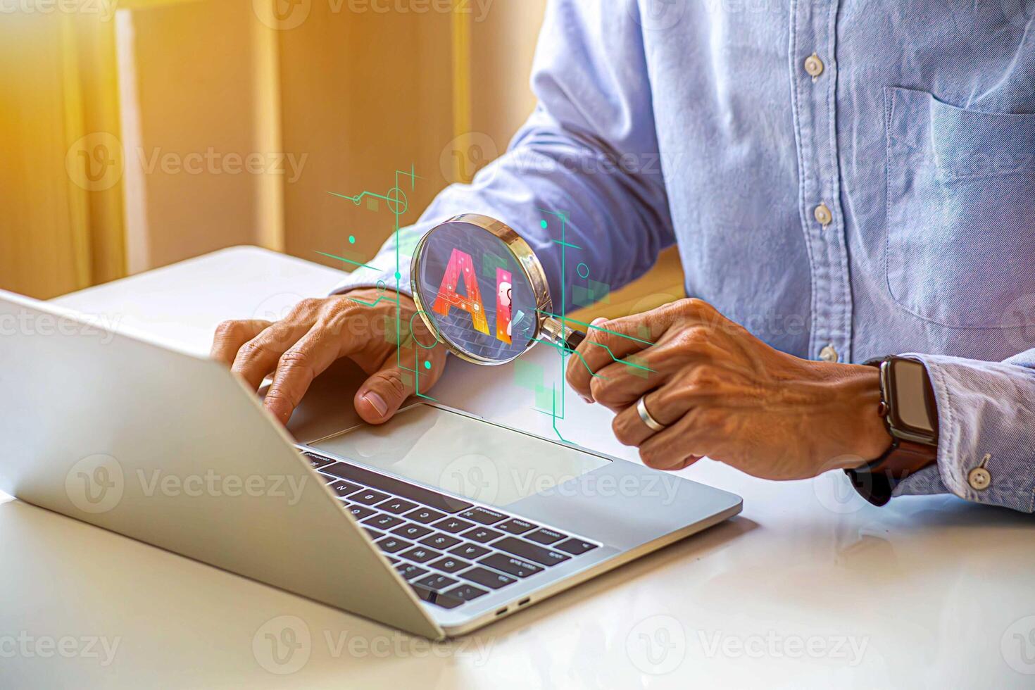 man using laptop with magnifying glass on it photo