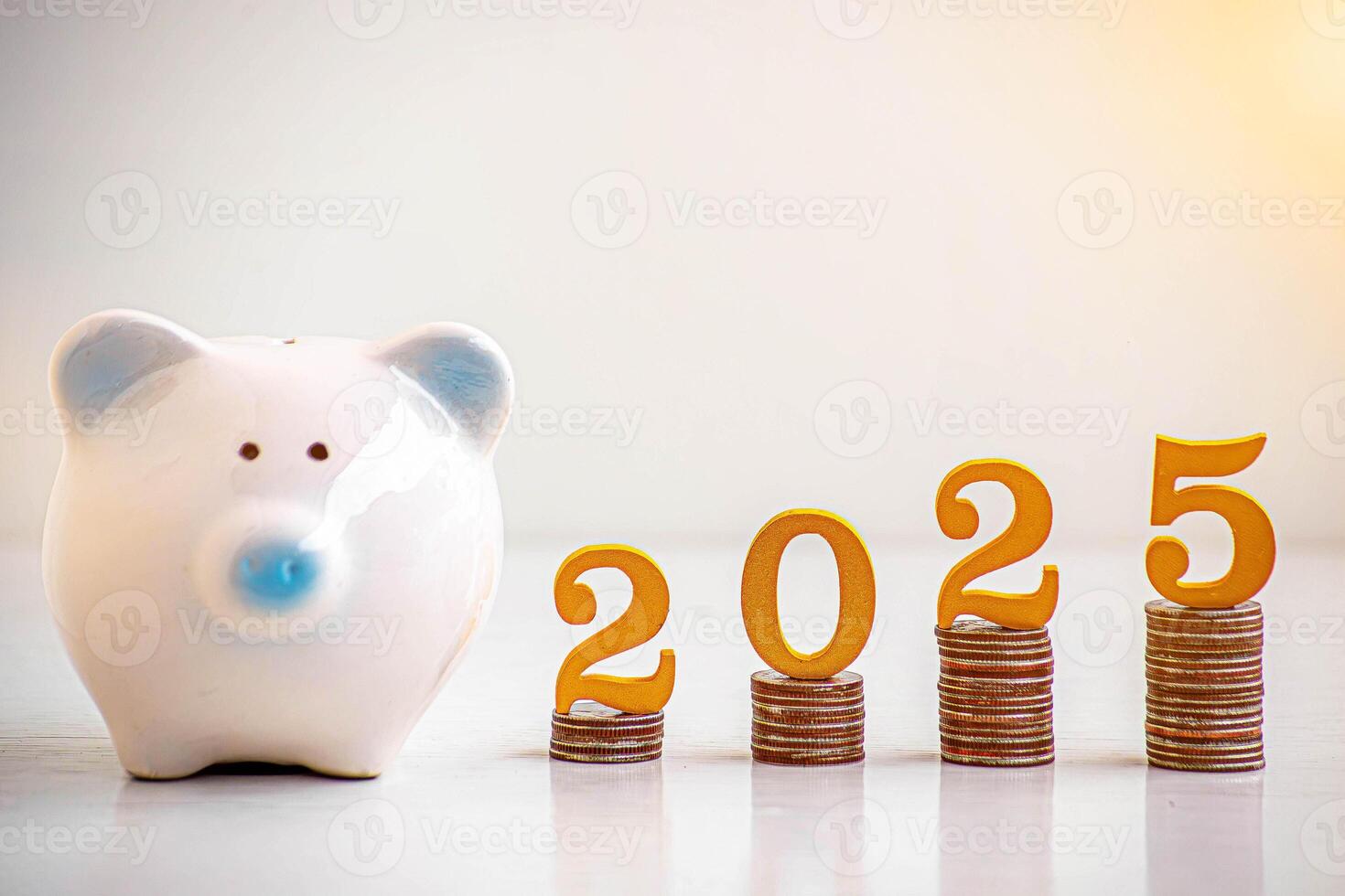 2025 New year saving money pig piggy bank with Wooden number 2025 Gold color on coins stack. Money-saving concept photo