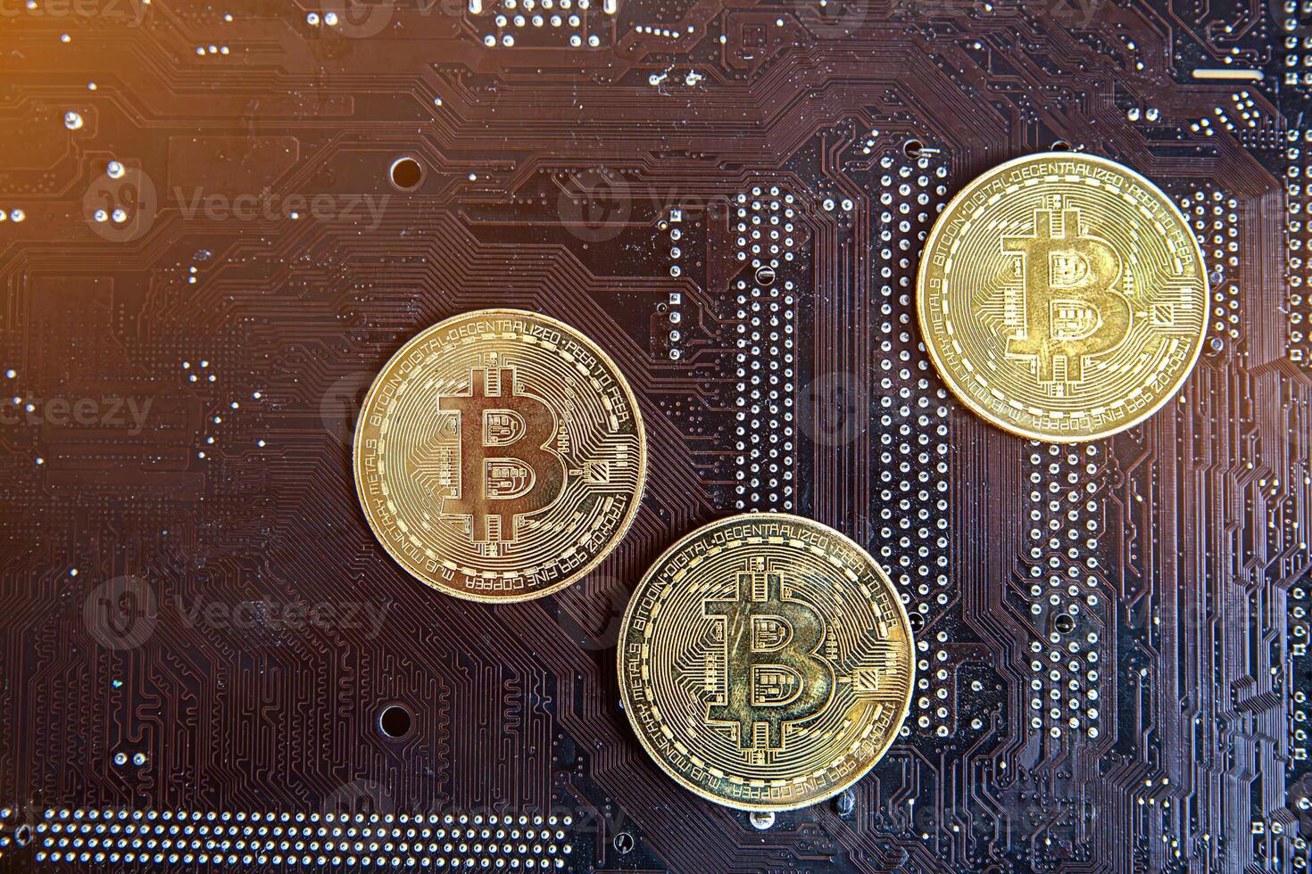 Gold souvenir coin Bitcoin on a computer circuit board background. photo