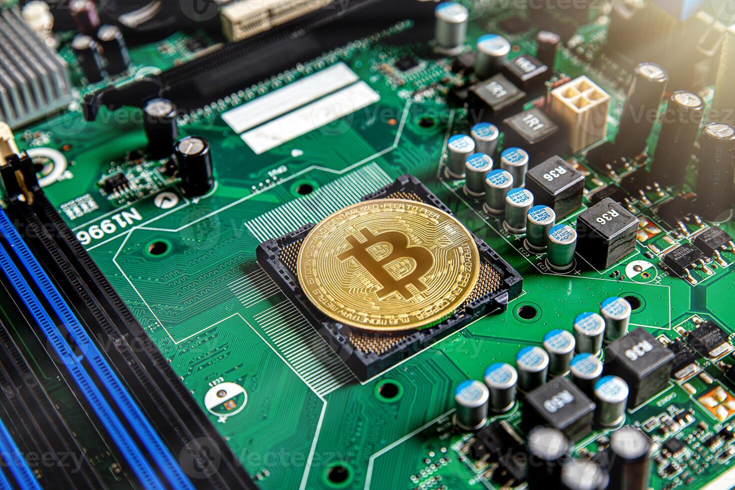 Gold souvenir coin Bitcoin on a computer circuit board background. photo