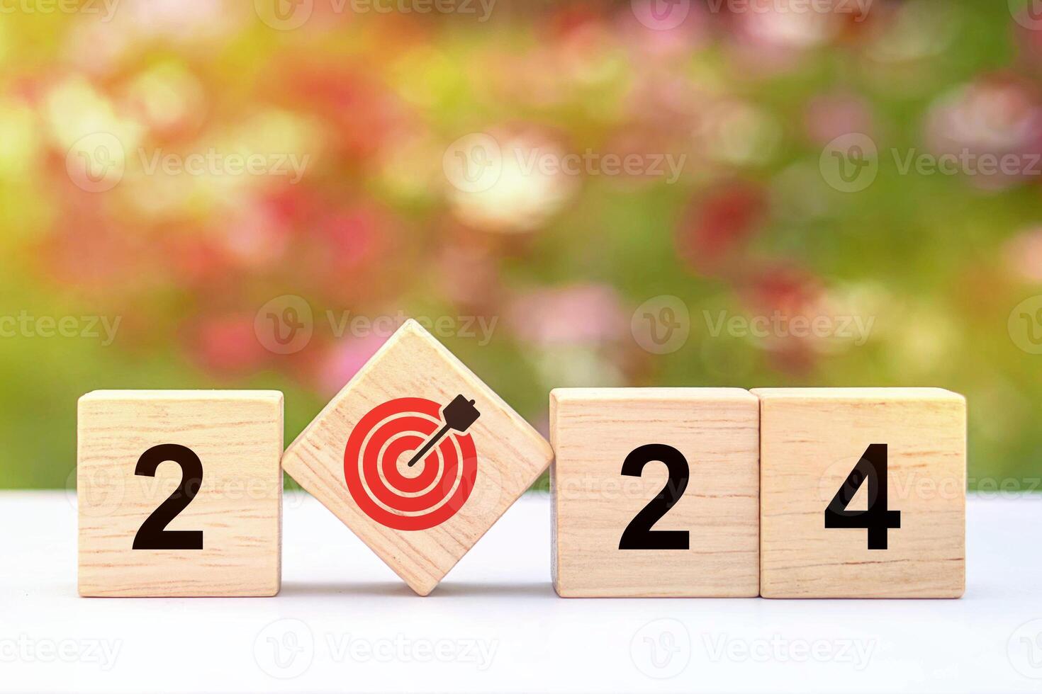 Trend of 2024. Wooden cube with word 2024 with target icon. photo
