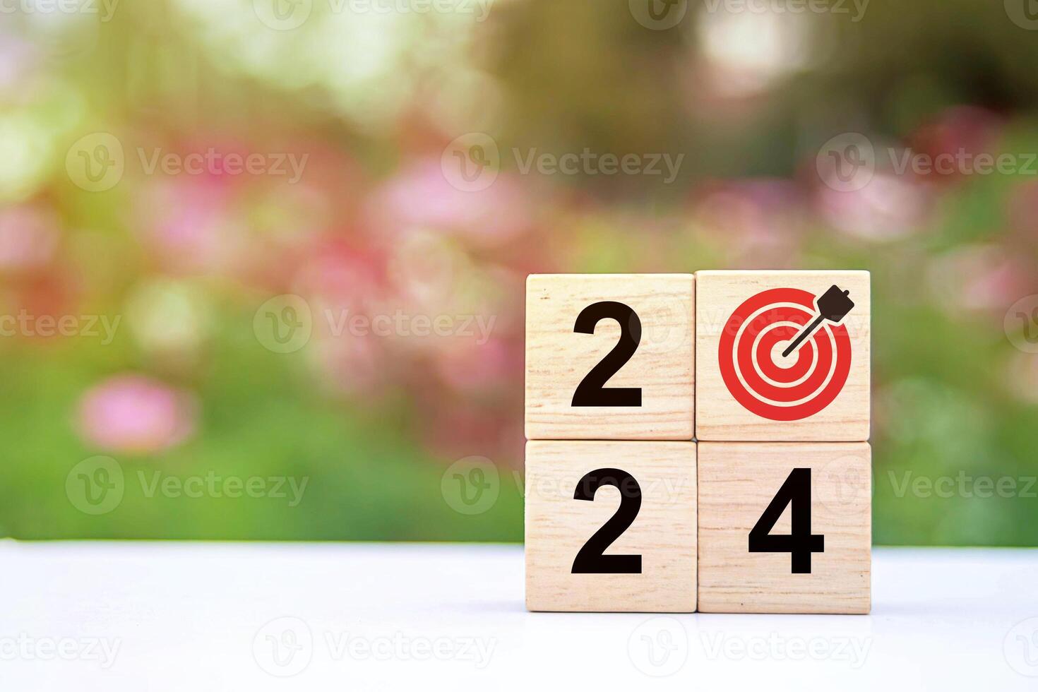 Trend of 2024. Wooden cube with word 2024 with target icon. photo