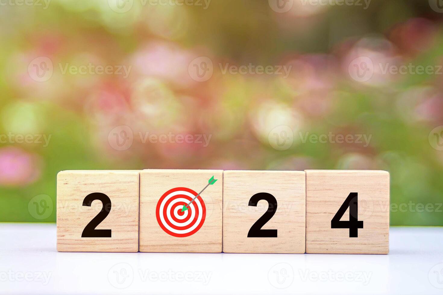 Trend of 2024. Wooden cube with word 2024 with target icon. photo