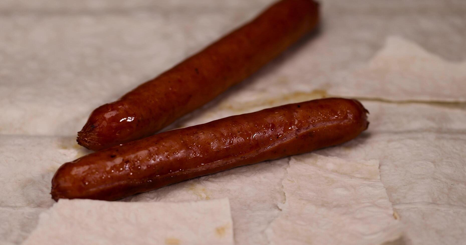 inverted sausages lying on wheat pita bread photo