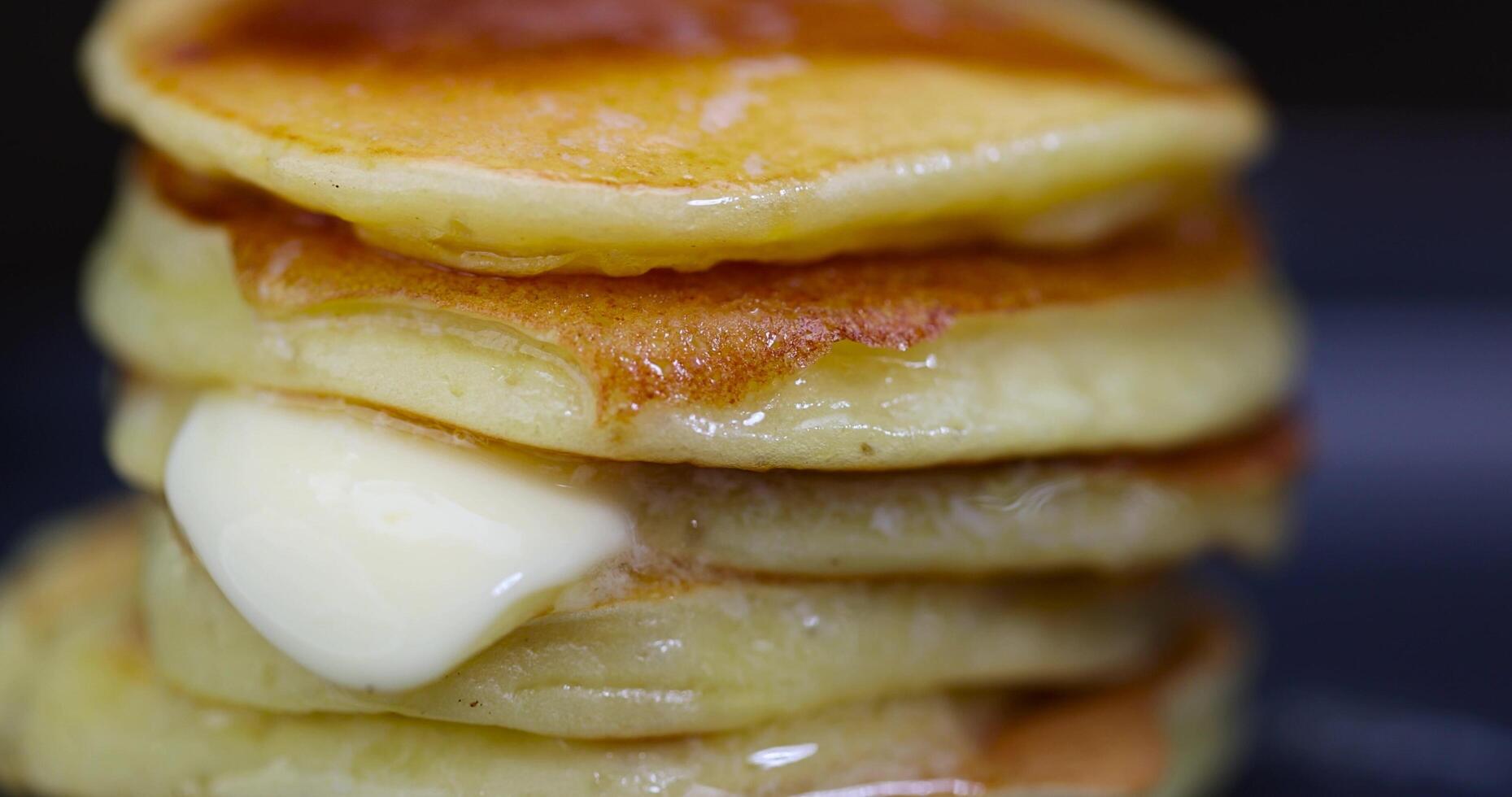 milk pancakes with butter on a blue plate photo