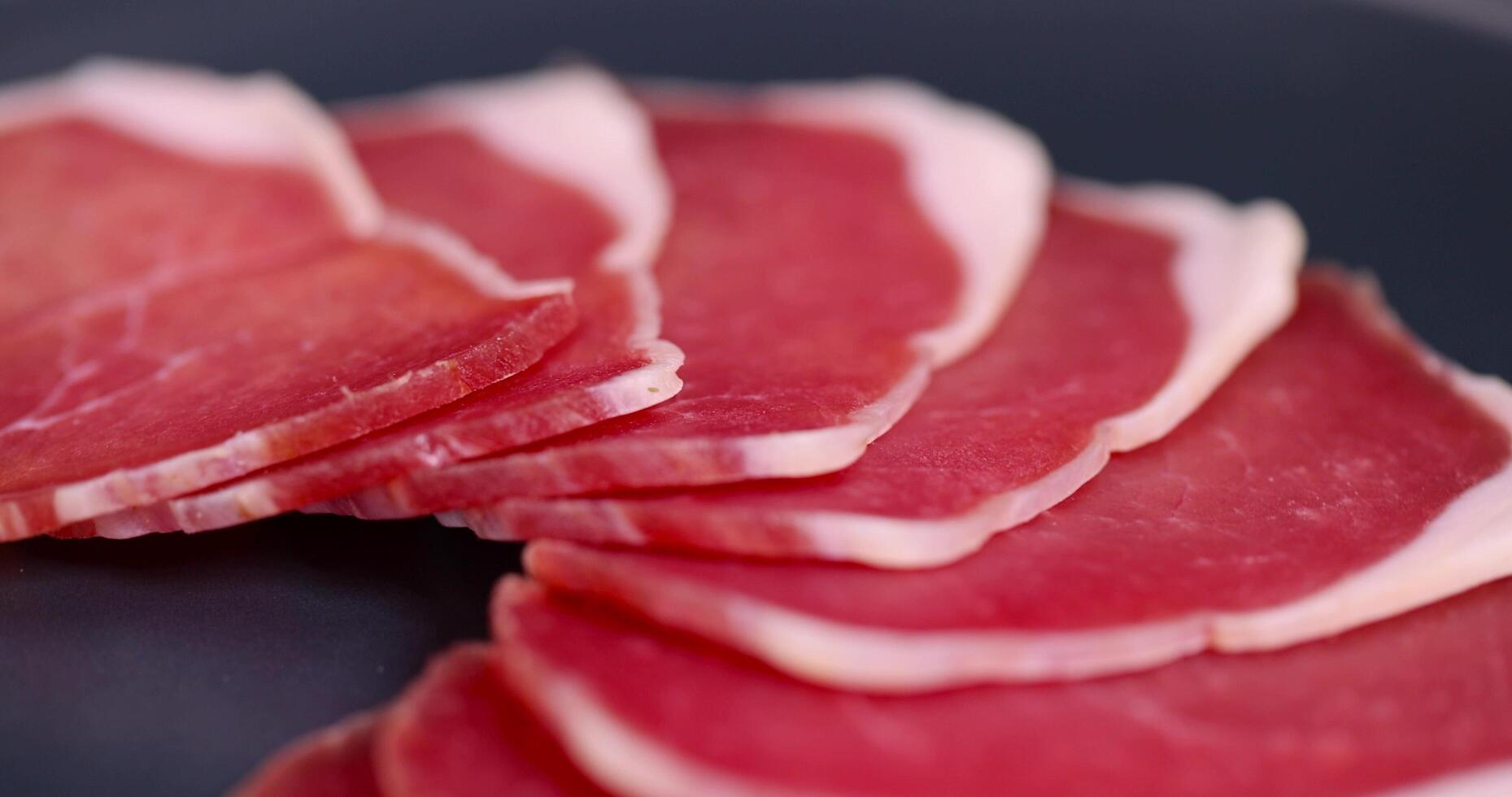 thinly sliced pork ham from a fillet for serving a festive table photo