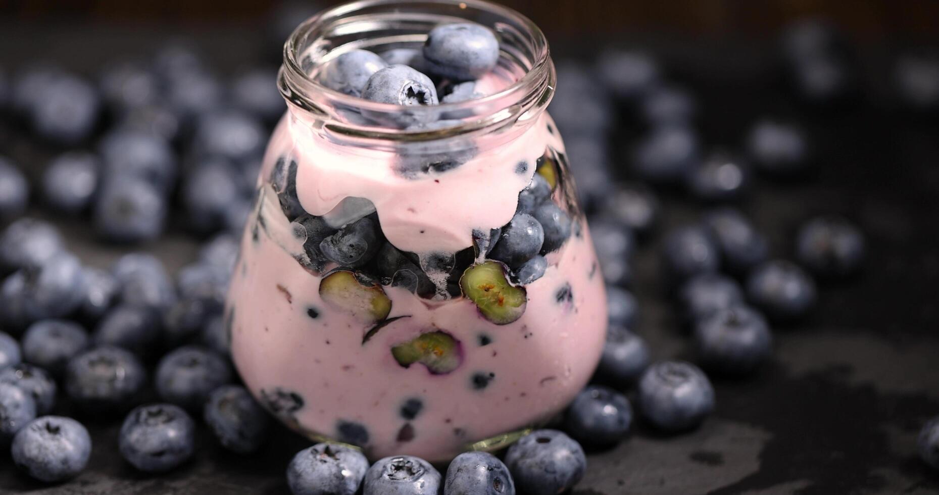 fresh cold yogurt with the taste and berries of ripe blueberries photo