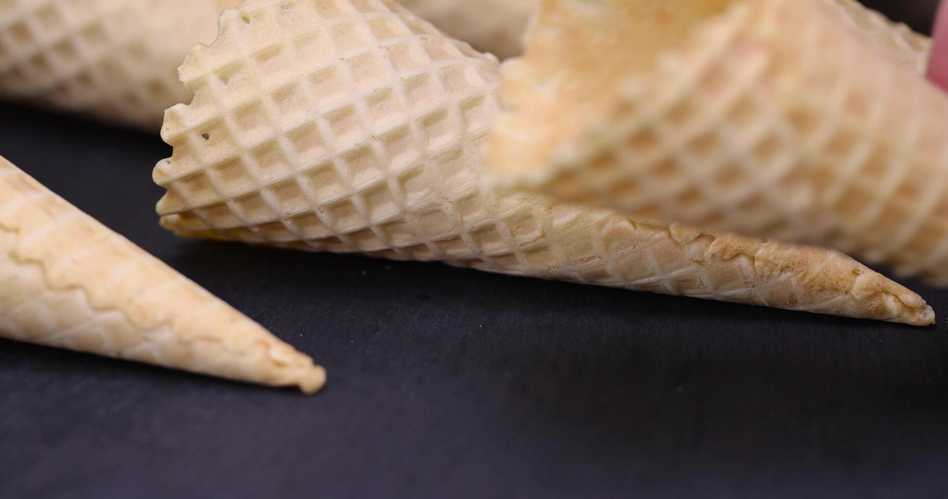 empty waffle cones for ice cream on a black slate photo