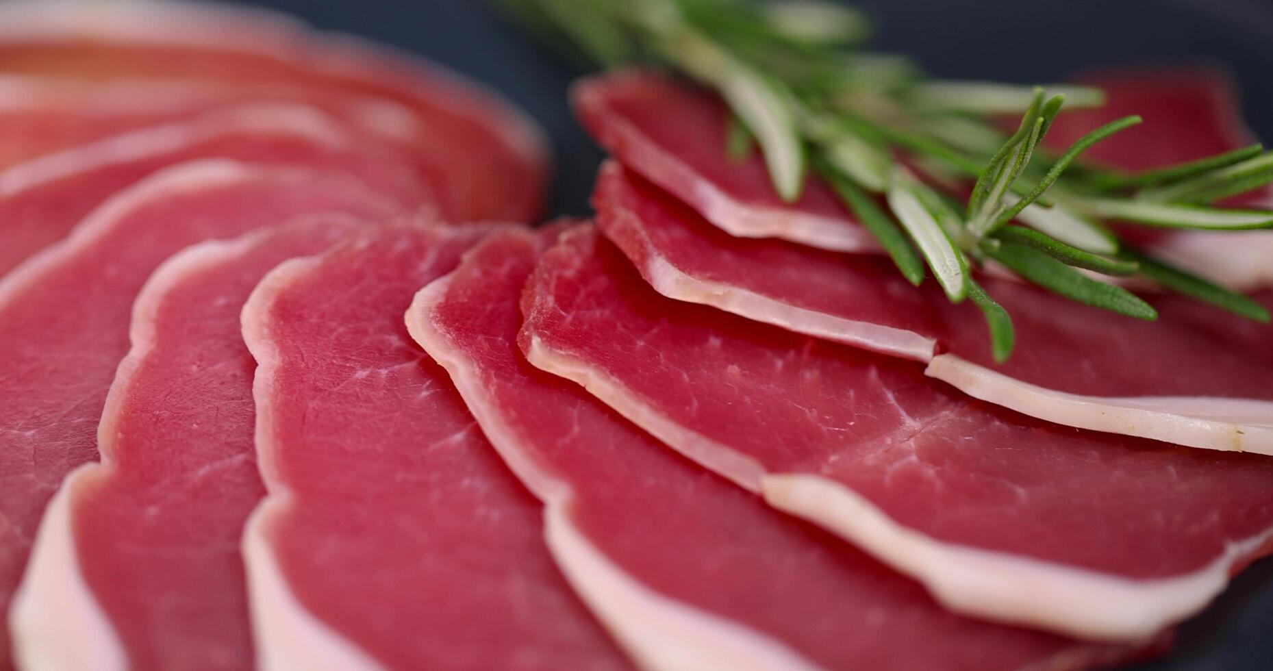 thinly sliced pork ham from a fillet for serving a festive table photo