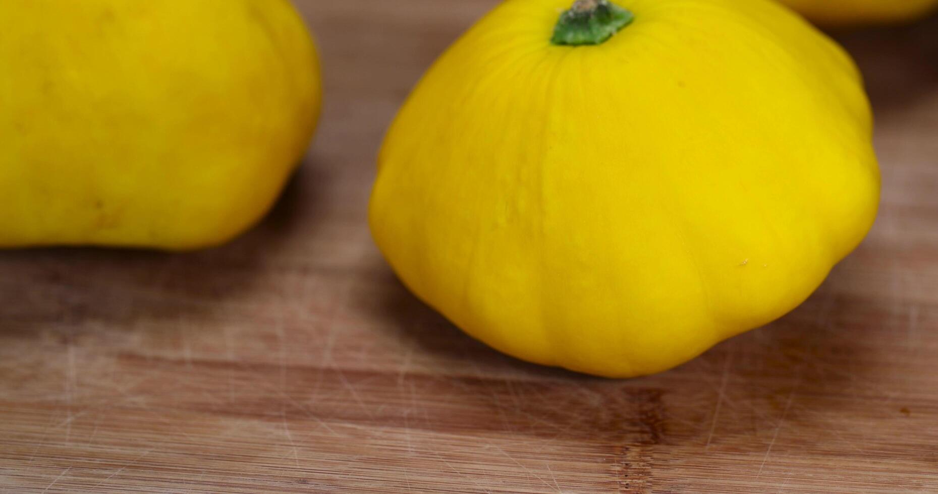 yellow ripe pumpkins on the table in close-up photo