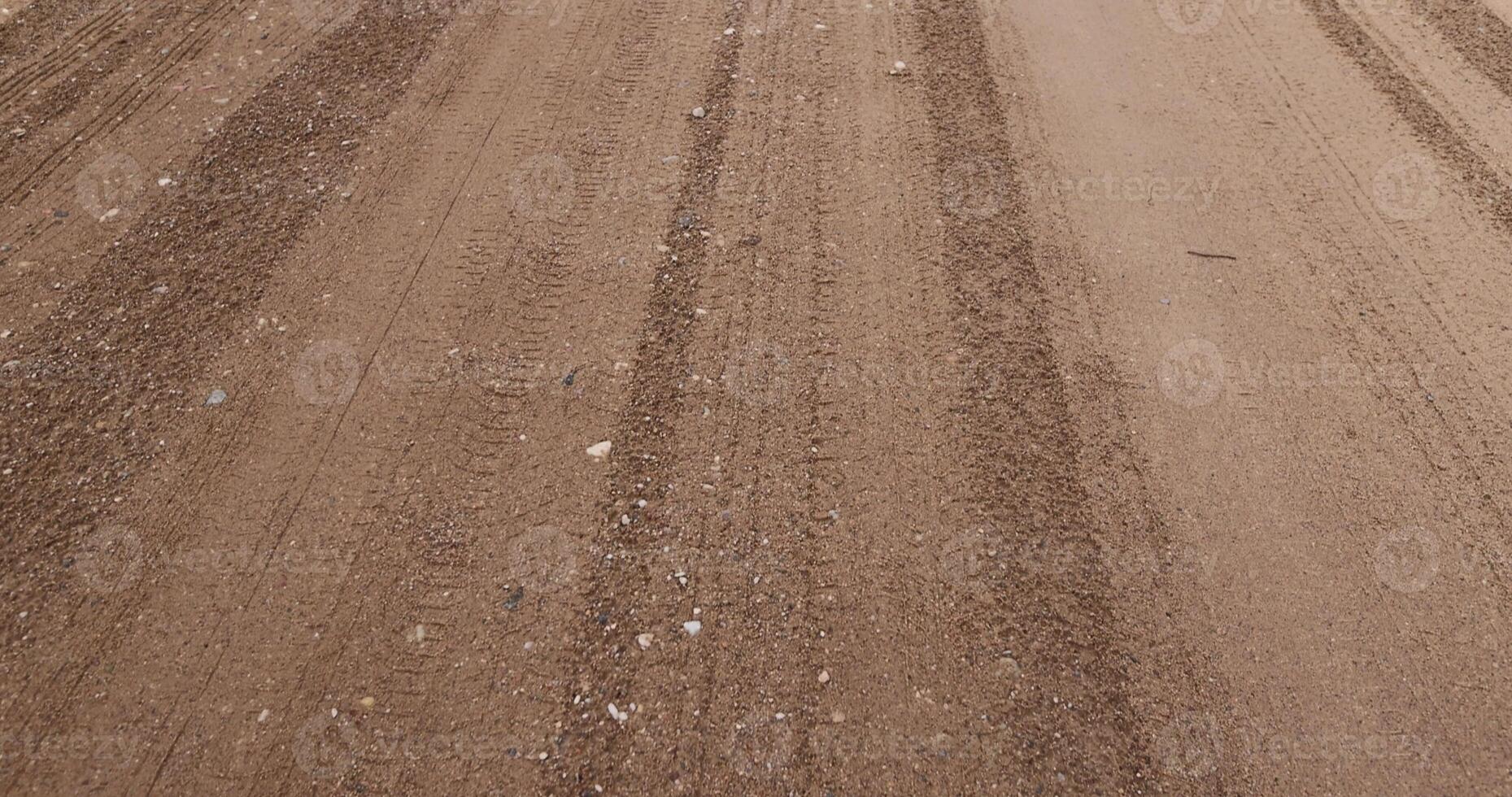 close-up of a part of a wet road without asphalt photo