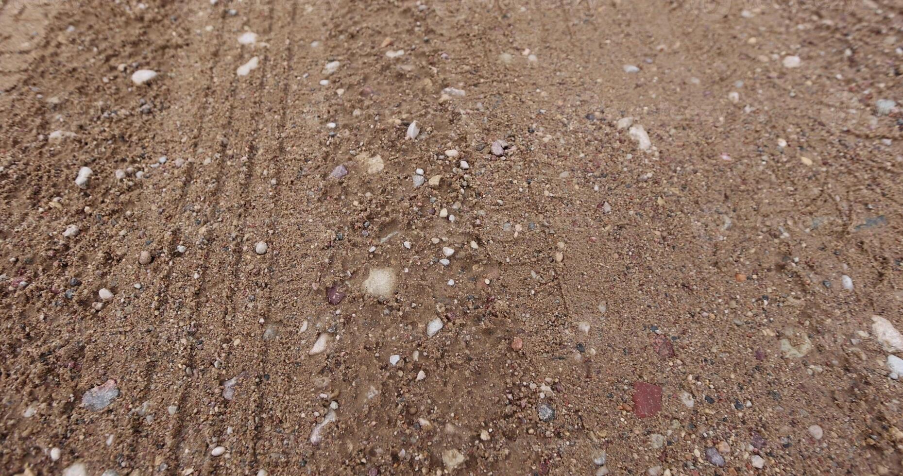 close-up of a part of a wet road without asphalt photo