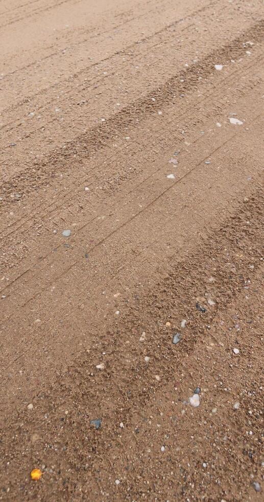 close-up of a part of a wet road without asphalt photo