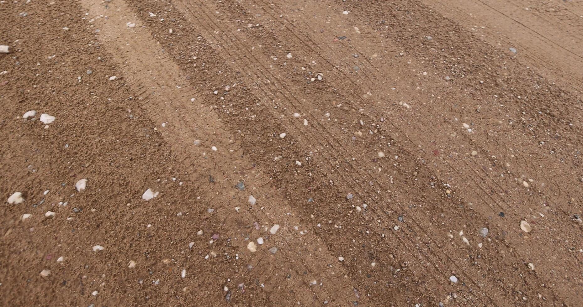 close-up of a part of a wet road without asphalt photo