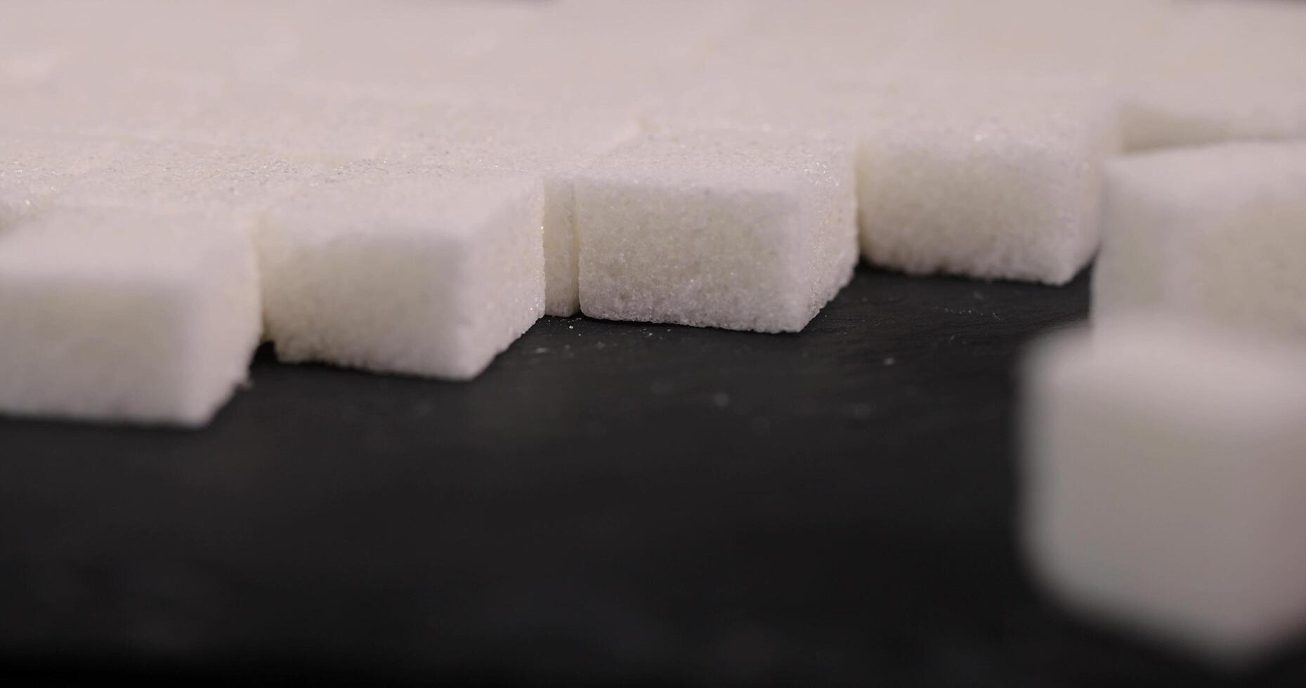 lump sugar in the shape of a square on a black slate photo