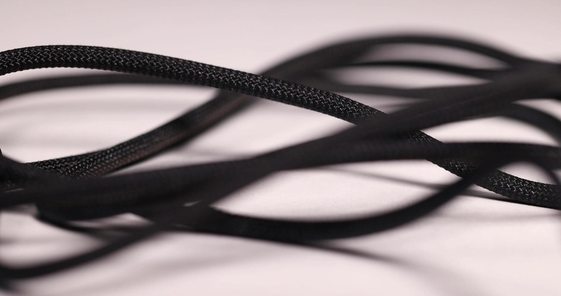 thin braided from black threads electric wire photo