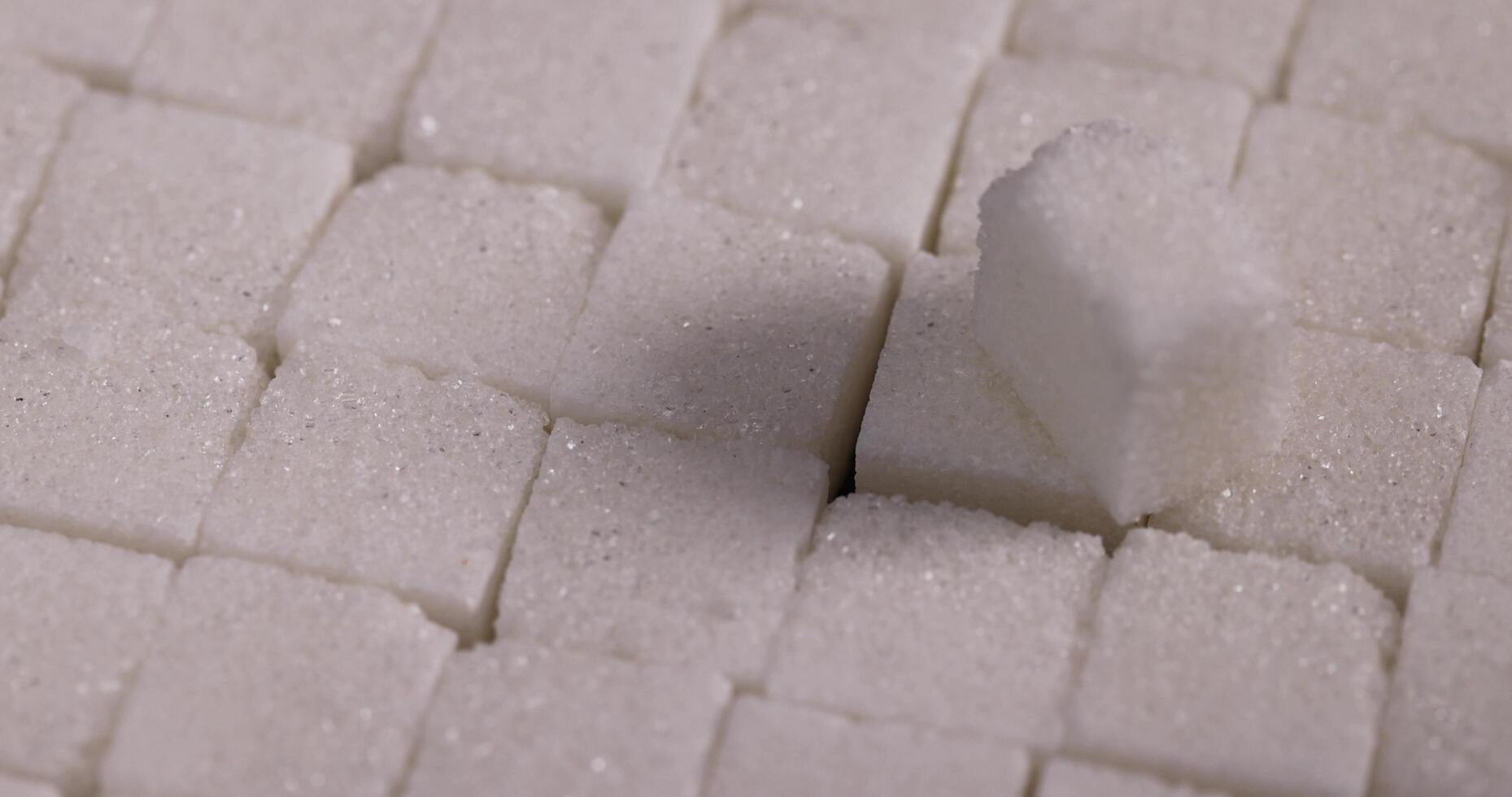 lump sugar in the shape of a square on a black slate photo