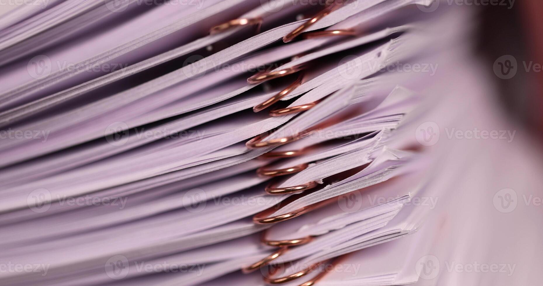 white blank sheets of paper connected by copper staples photo