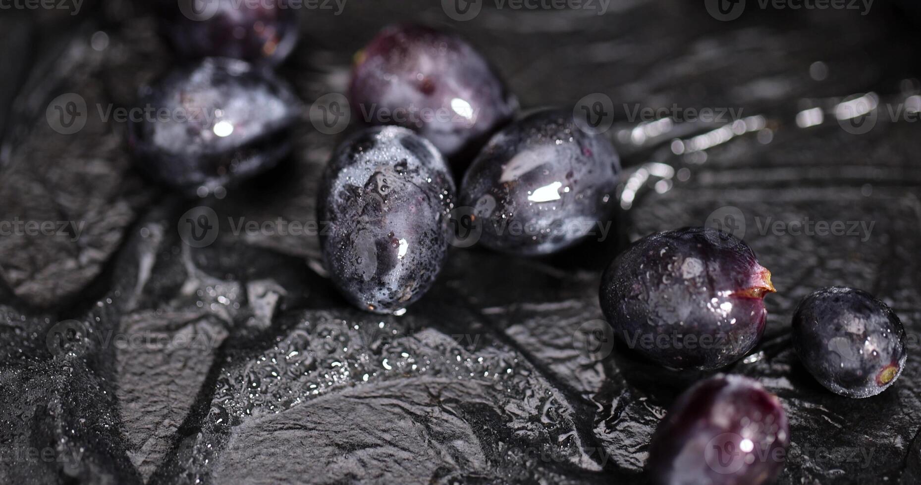 fresh grapes are lying on black paper photo