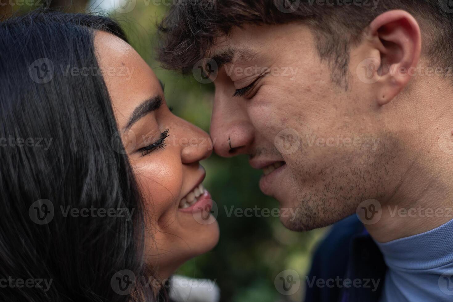 portrait of young multiethnic latin caucasian couple kissing photo