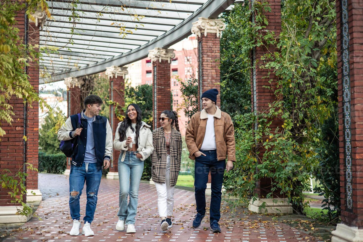 group of four university friends returning from class photo