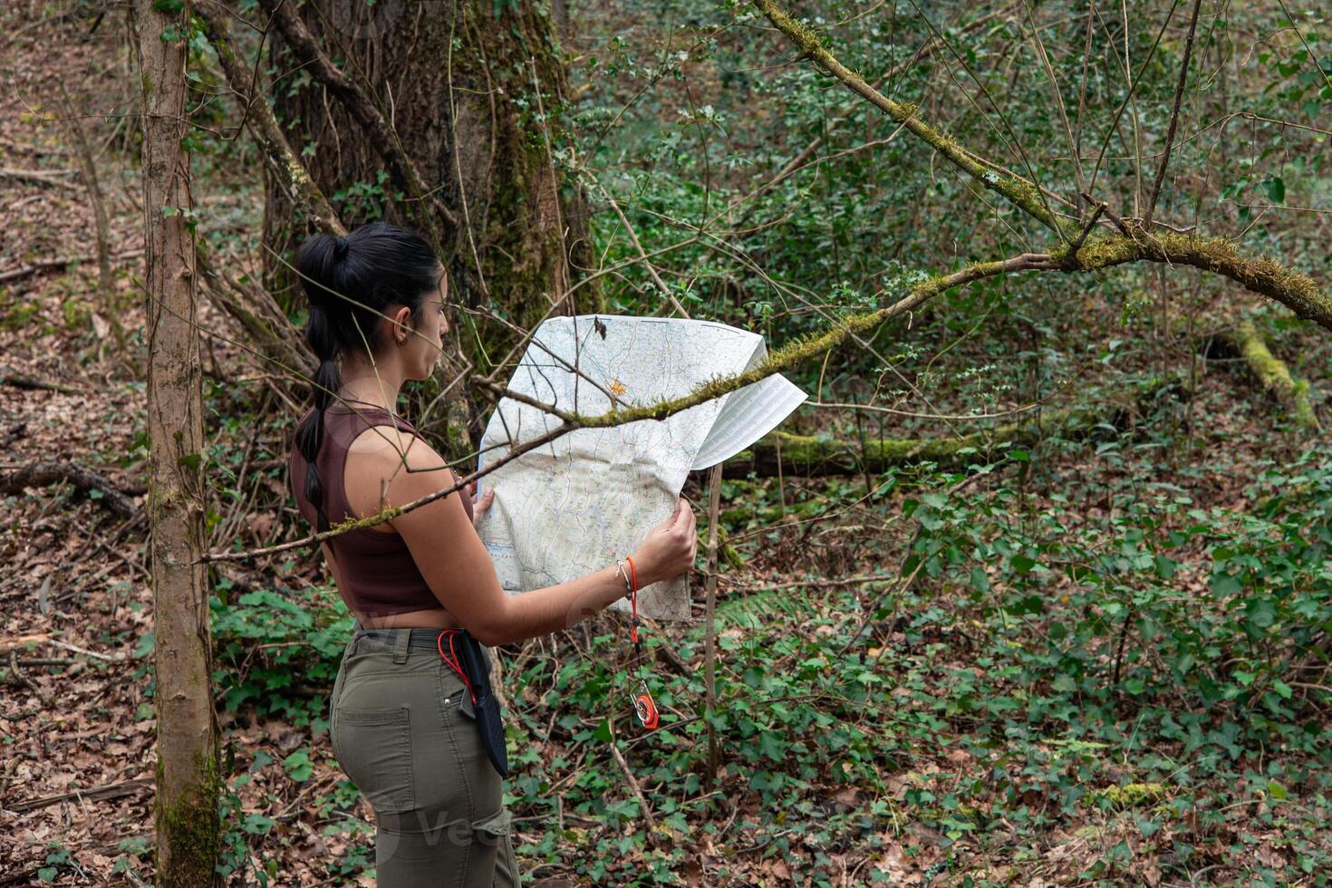 Navigating the Wild Young Explorer girl with Map in Hand photo