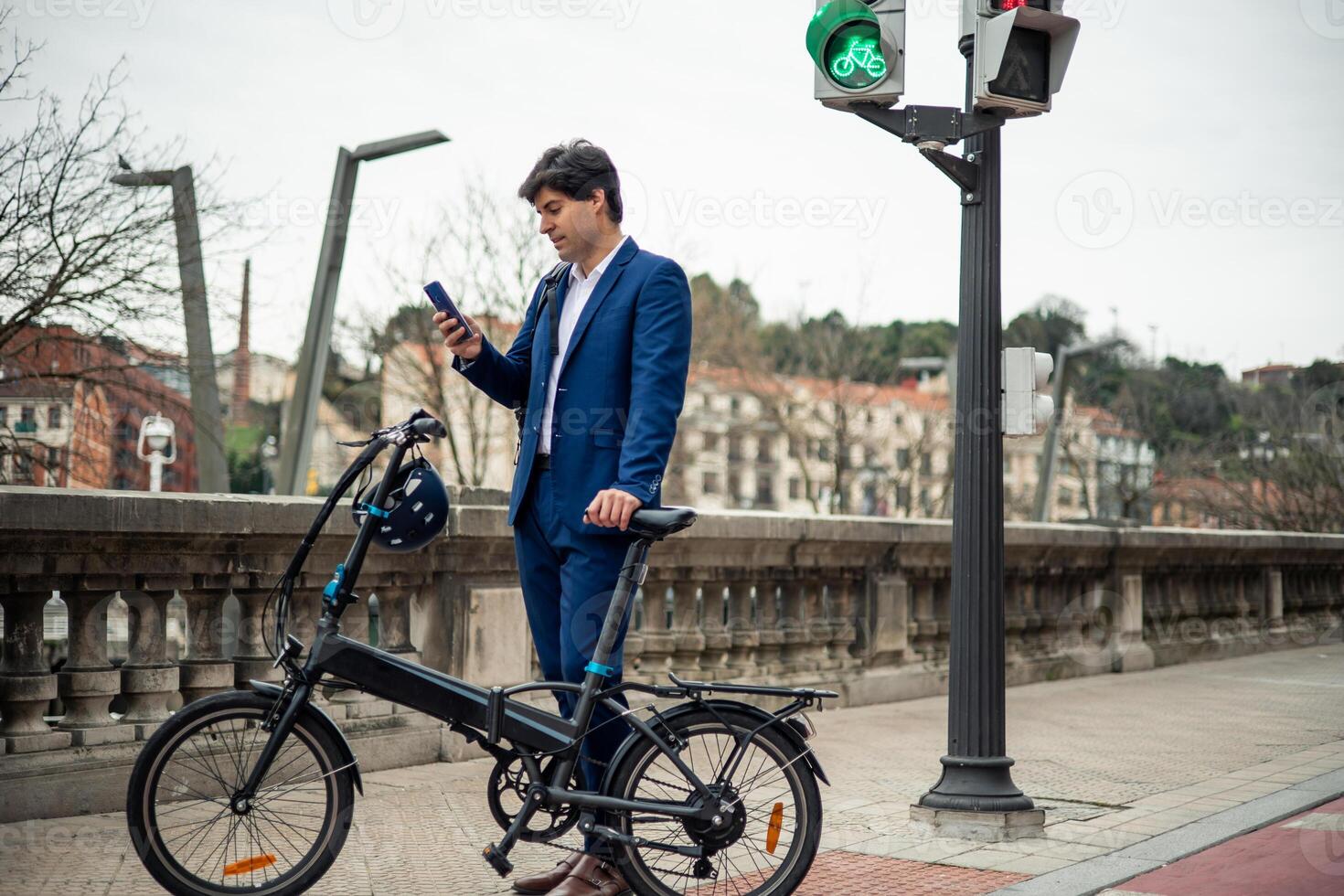 Urban Commuter businessman Multitasking with Electric Folding Bike and Smartphone copyspace photo