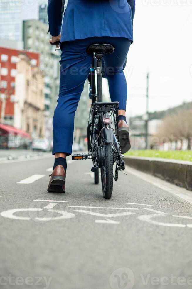 vertical portrait closeup of Businessman Commuting on Electric Bike in City Bike Lane photo