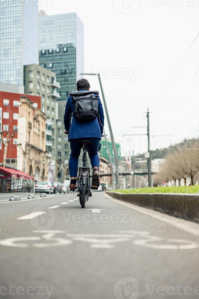 vertical portrait Sustainable Urban Commute Businessman Cycling Safely in Dedicated Bike Lane photo