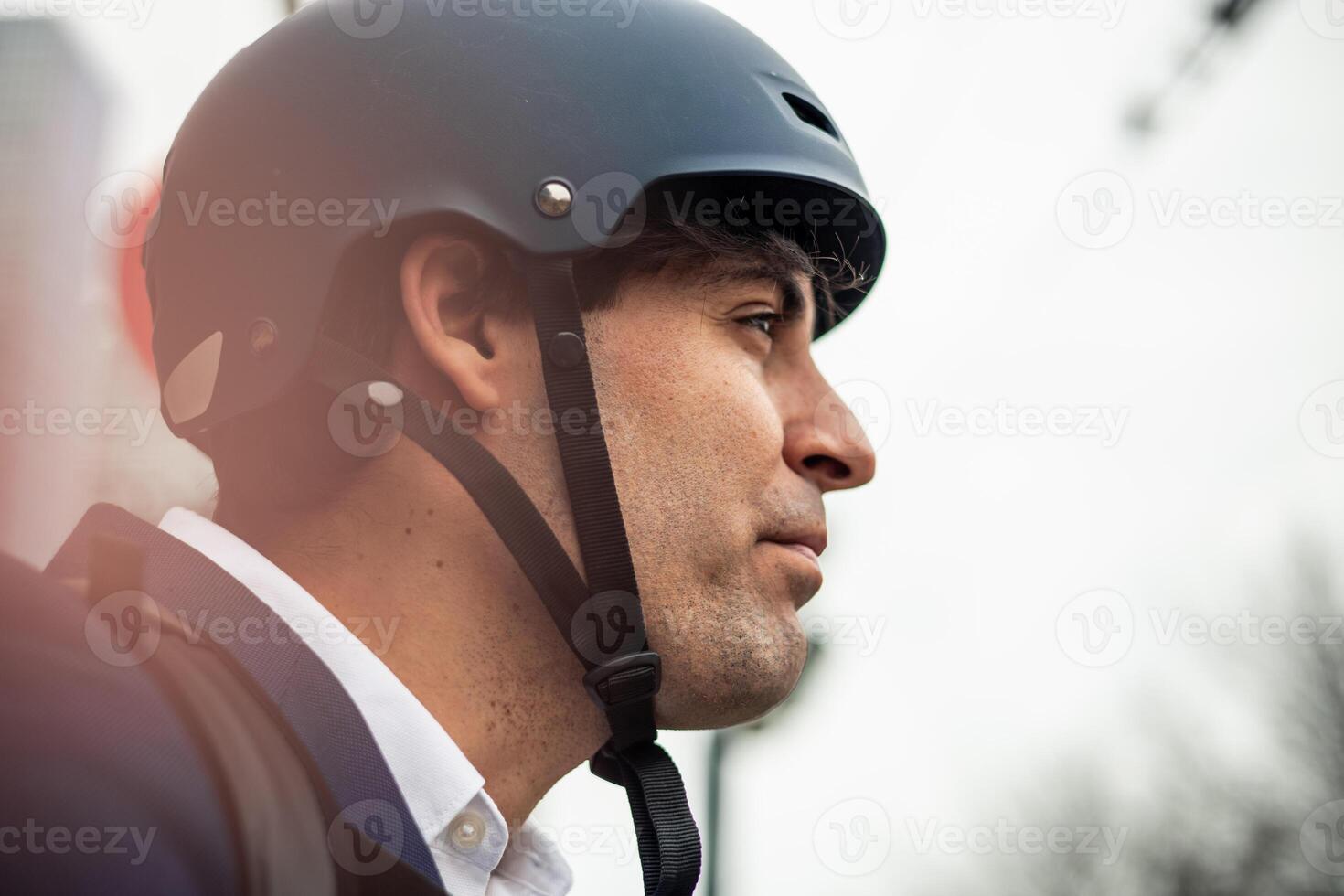 closeup of Businessman face in Suit with Bicycle Helmet photo
